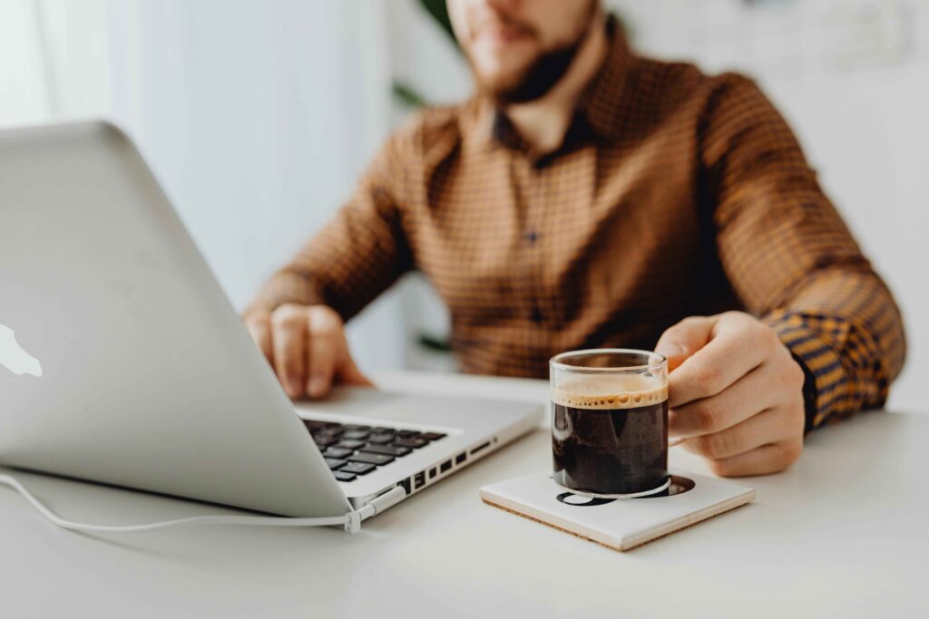 No.1 digital marketing freelancer in India working on a laptop with a cup of coffee on the desk, representing productivity and digital expertise.